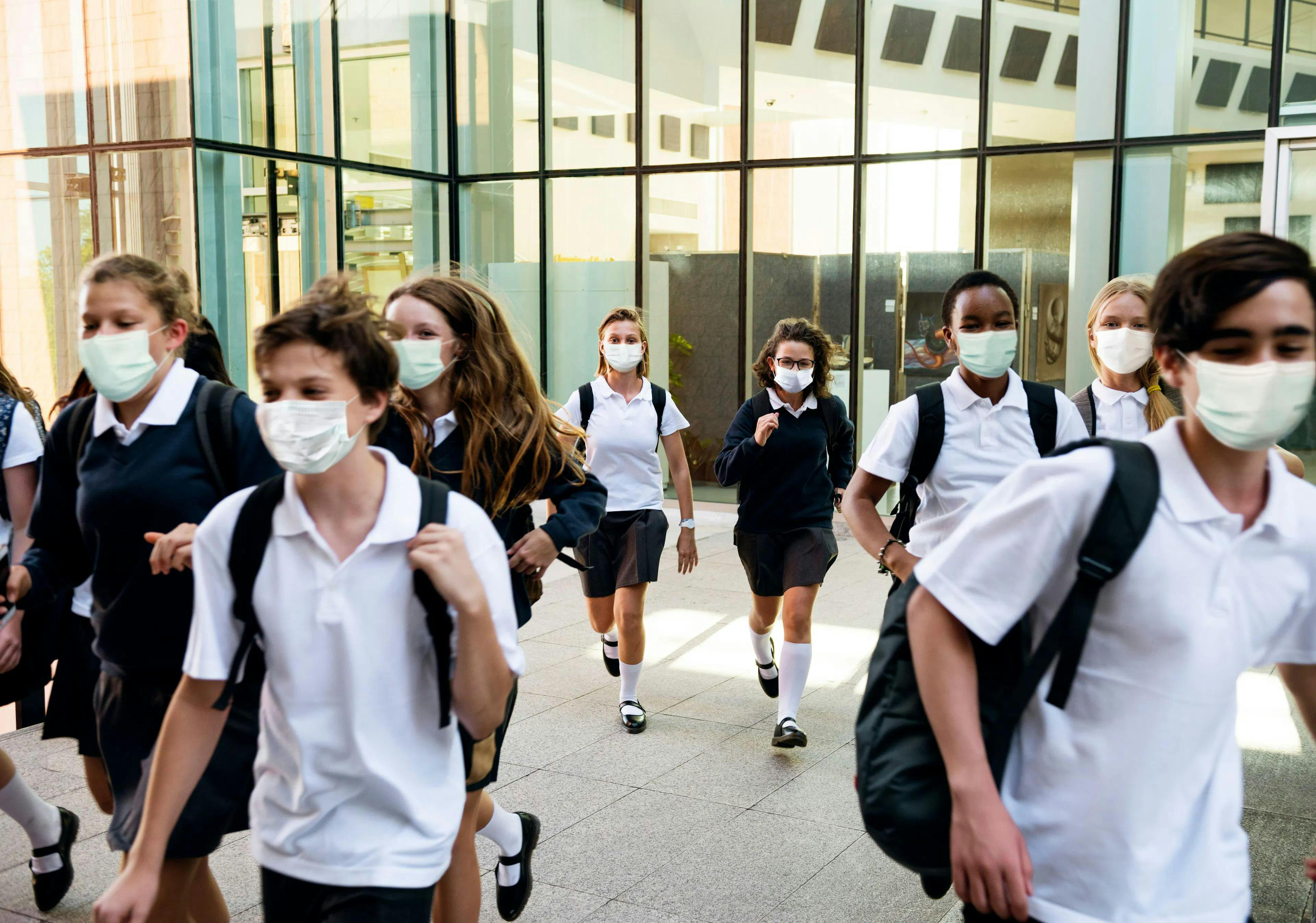 Differing Strategies for Monitoring Influenza and COVID-19 in Schools