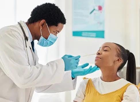 Doctor testing patient for COVID | Image Credits: Unsplash